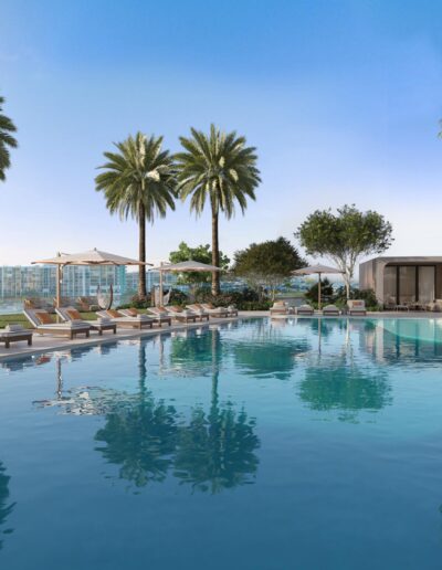 Infinity-edge pool surrounded by palm trees at a luxury waterfront condo in Miami